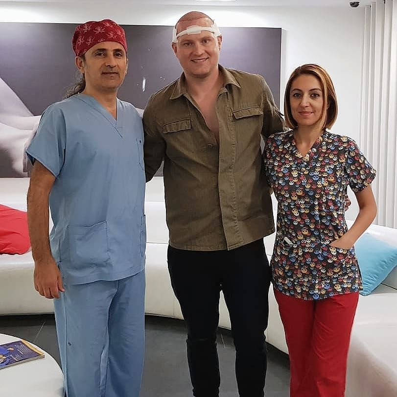 Medical professionals with hair transplant patient